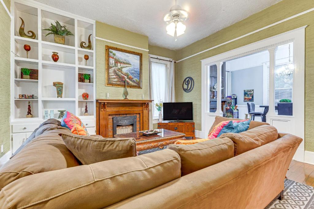 a living room with a couch and a fireplace at Walk to Downtown Historic Home in Mobile in Mobile