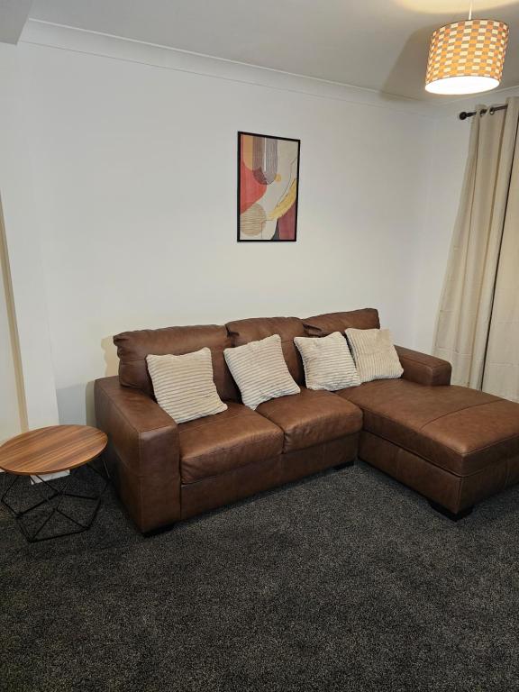 a brown leather couch in a living room at Awesome Coventry Home from Home for Business Contractors and Suitable for families with Free WI-FI Free Parking in Coventry