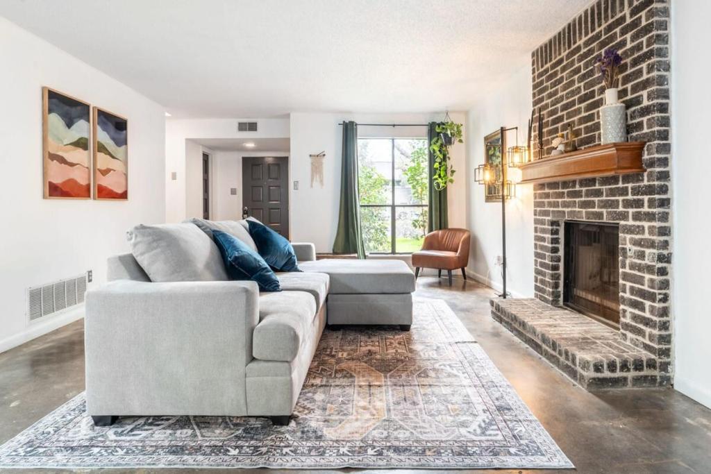 a living room with a couch and a fireplace at Pet-Friendly Southwest Austin Home with BBQ in Austin