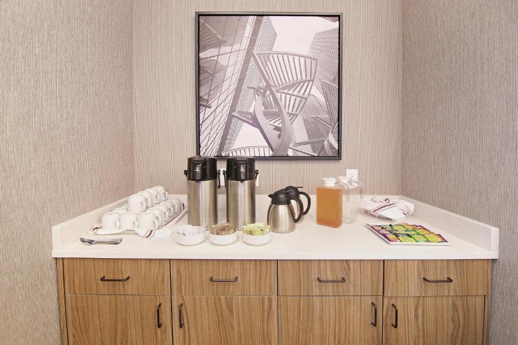 a counter in a hotel room with a coffee maker at Holiday Inn Hotel & Suites - Calgary Airport North by IHG in Calgary