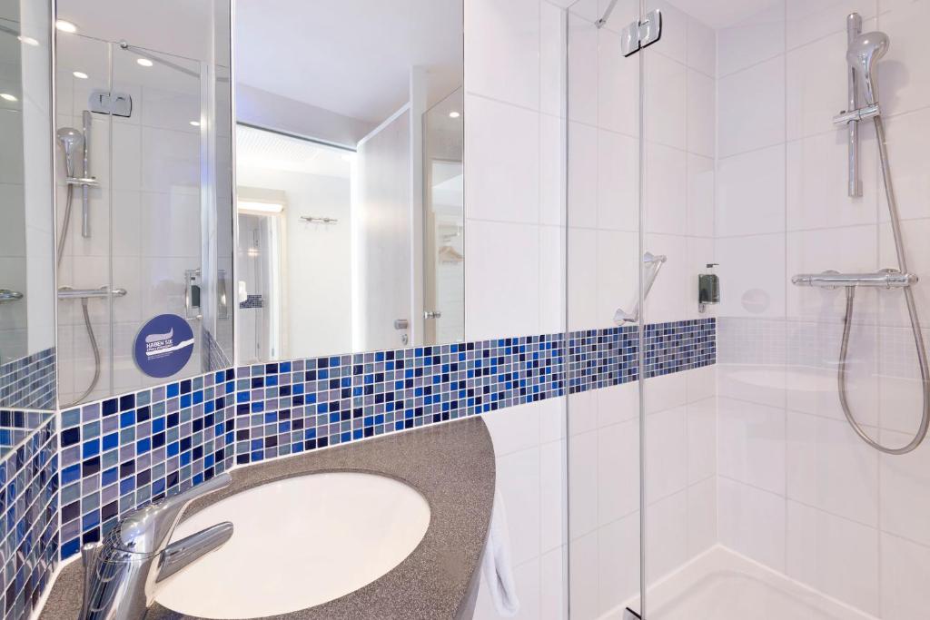 a bathroom with a sink and a shower at Holiday Inn Express Singen, an IHG Hotel in Singen