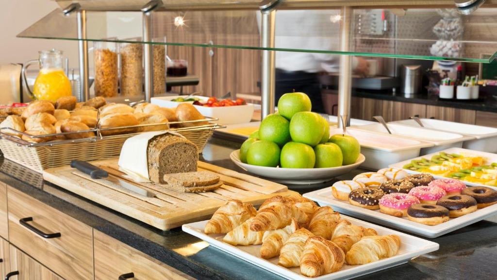 a buffet line with various pastries and other foods at Holiday Inn Express Singen, an IHG Hotel in Singen