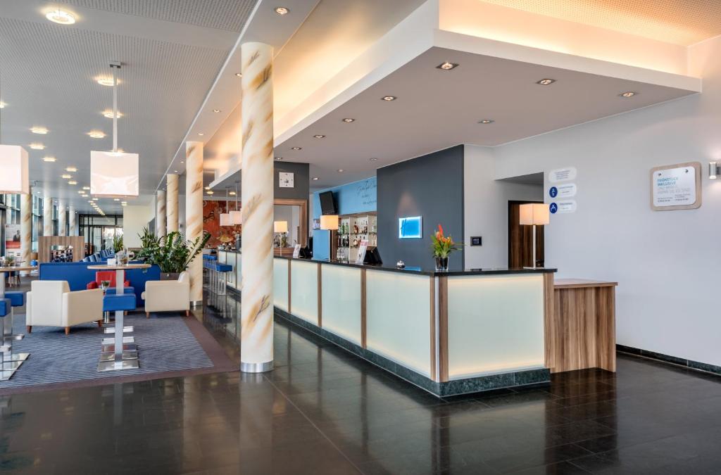 a lobby of a store with a counter and chairs at Holiday Inn Express Singen, an IHG Hotel in Singen