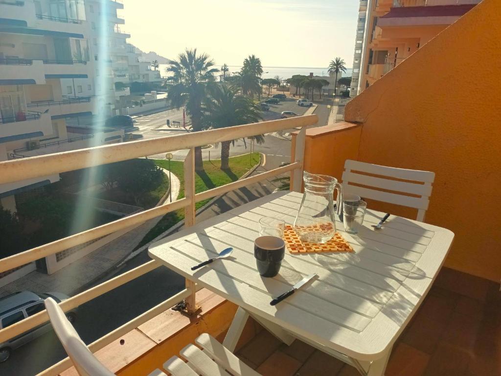 a white table on a balcony with a view of a city at Apartamento Roses, 1 dormitorio, 4 personas - ES-258-83 in Roses