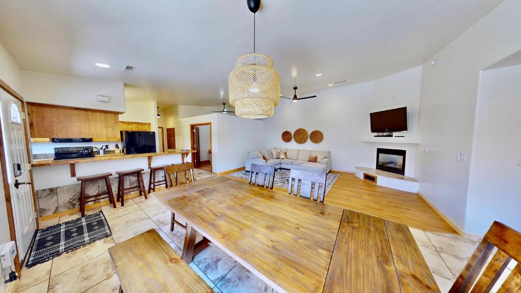 a living room with a table and a kitchen at Canyon Portal #469 in Moab