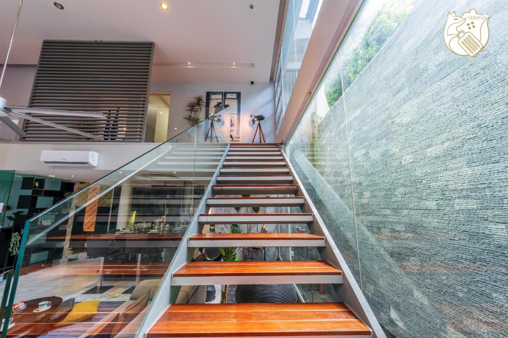 a staircase in a building with a glass wall at 6BR Homestay KL Pool Villa - 4KM To KLCC by Verano in Ampang