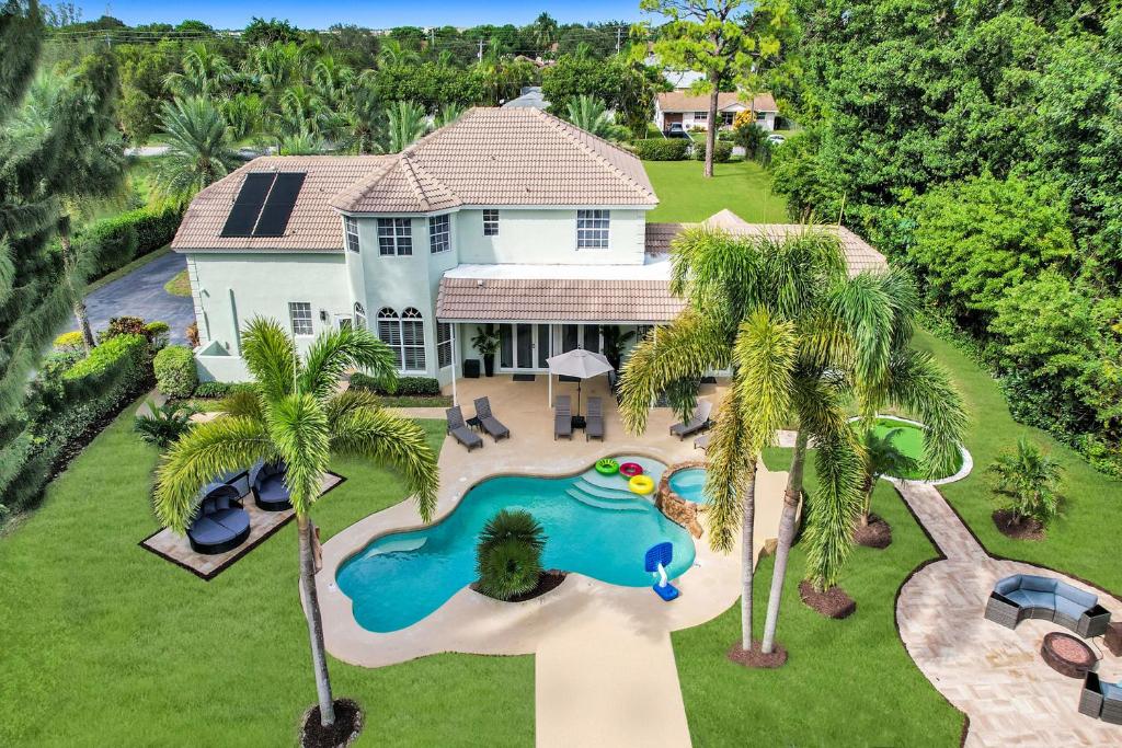 an aerial view of a house with a swimming pool at Luxurious 8BR Dream Estate w Private Heated Pool in Pompano Beach