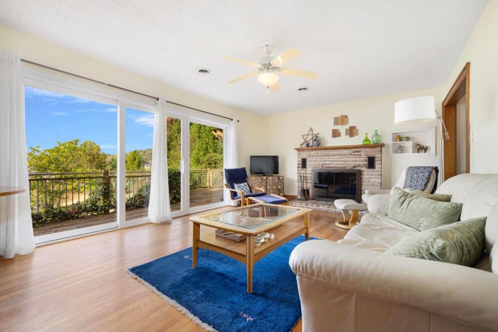 a living room with a couch and a table at 3BR Boone Lakefront home in Piney Flats