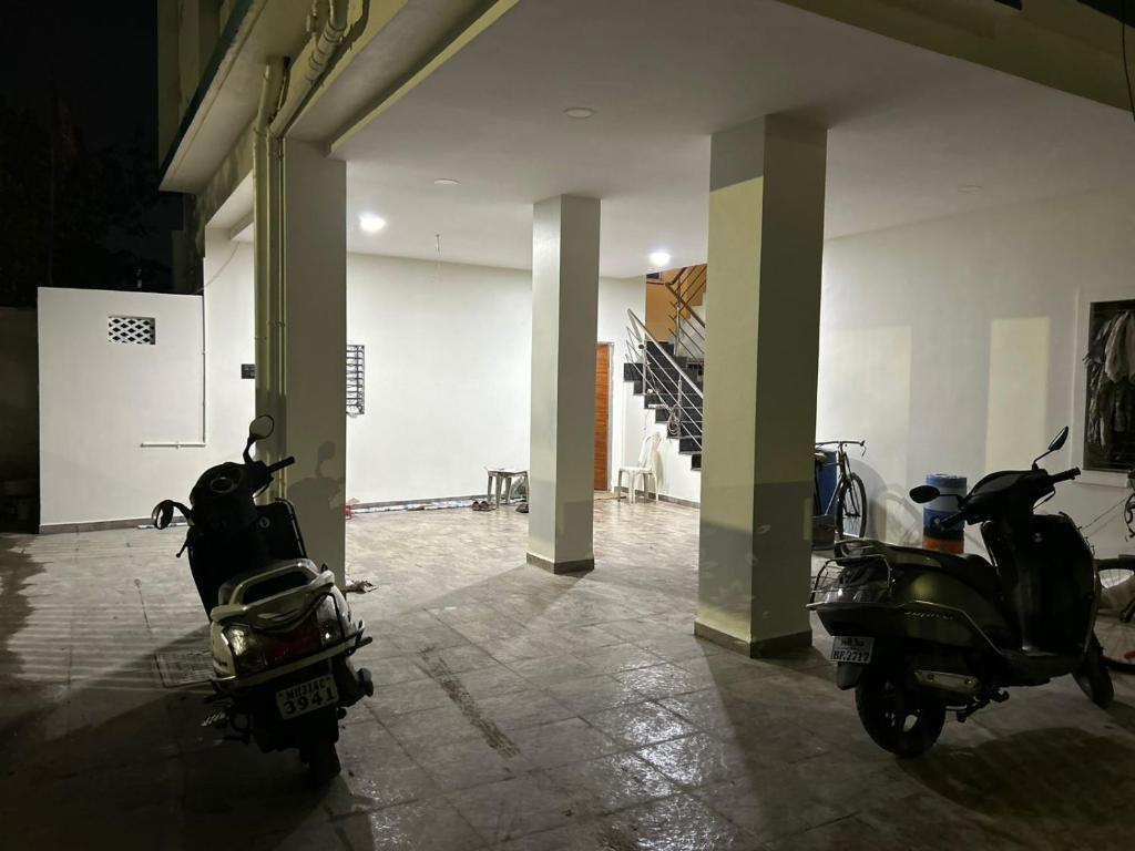 two motor scooters parked in a hallway in a building at 1BHK Holiday Home in Nagpur