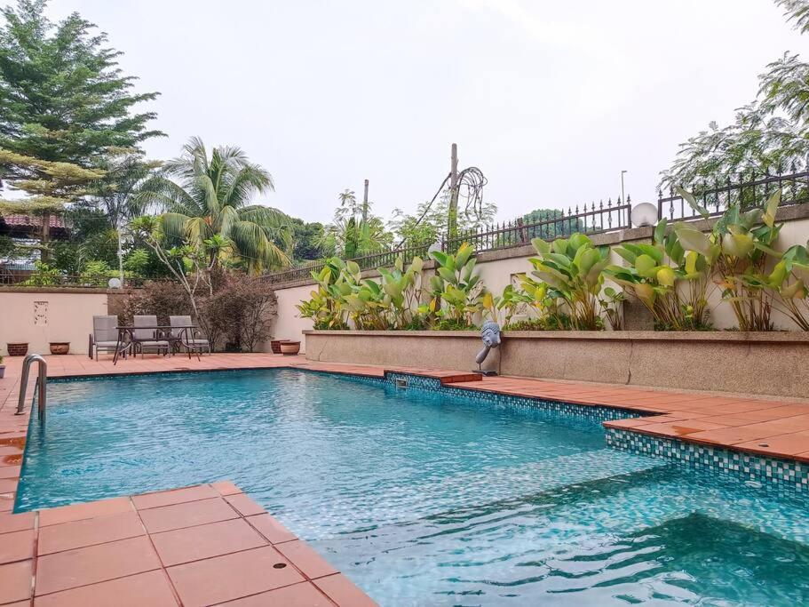 a large swimming pool with a person standing next to it at KL Secret Karaoke Private Pool Villa in Ampang