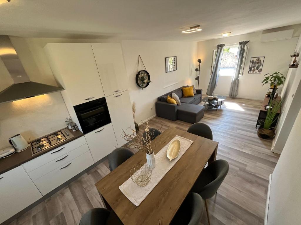 a kitchen and living room with a table and chairs at Holiday Home Kristin in Mirce