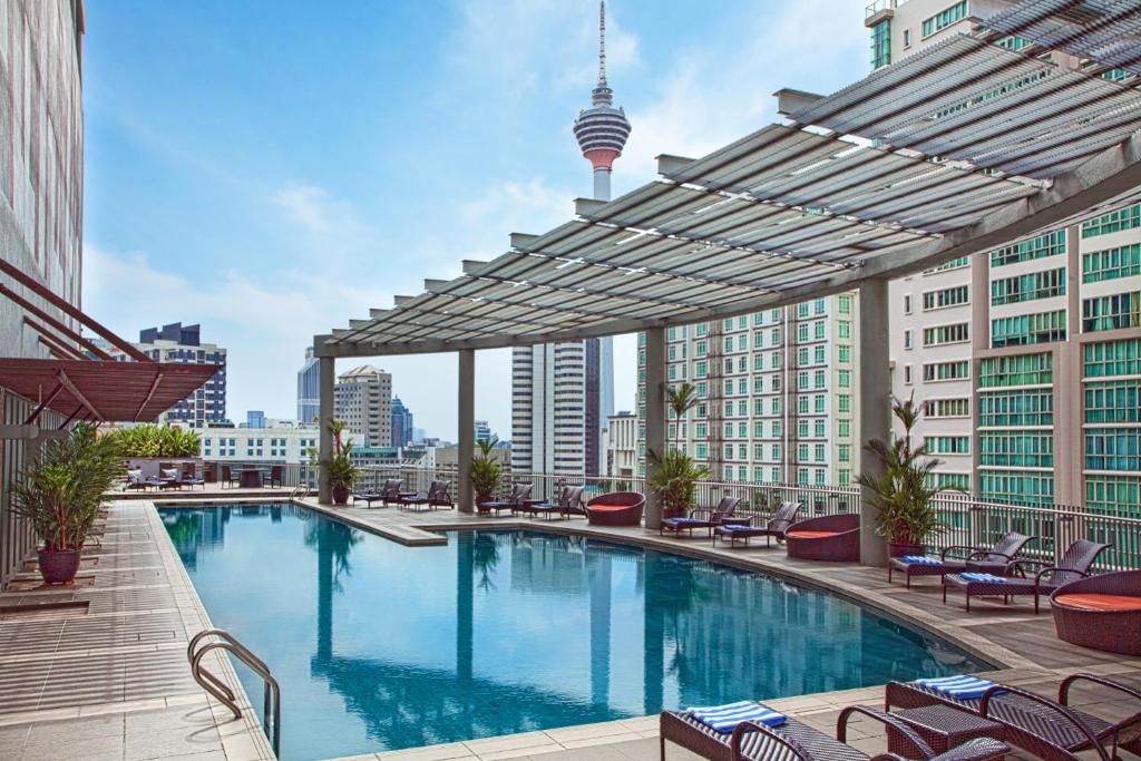 a large swimming pool on the roof of a building at Ascott Kuala Lumpur in Kuala Lumpur