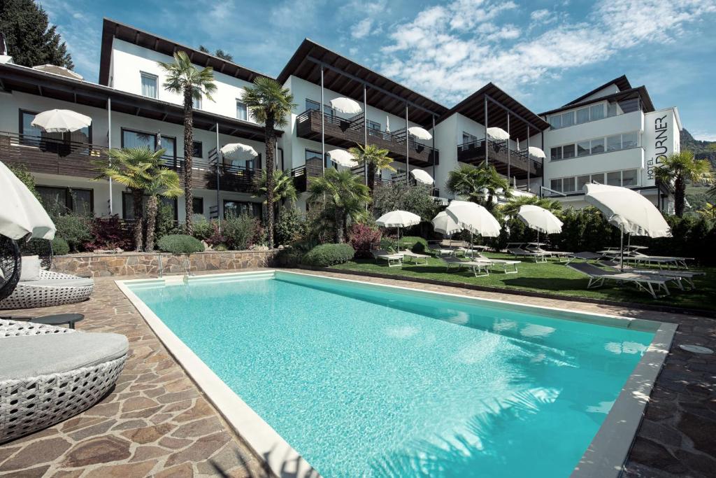 uma piscina em frente a um edifício em Hotel Ladurner em Merano