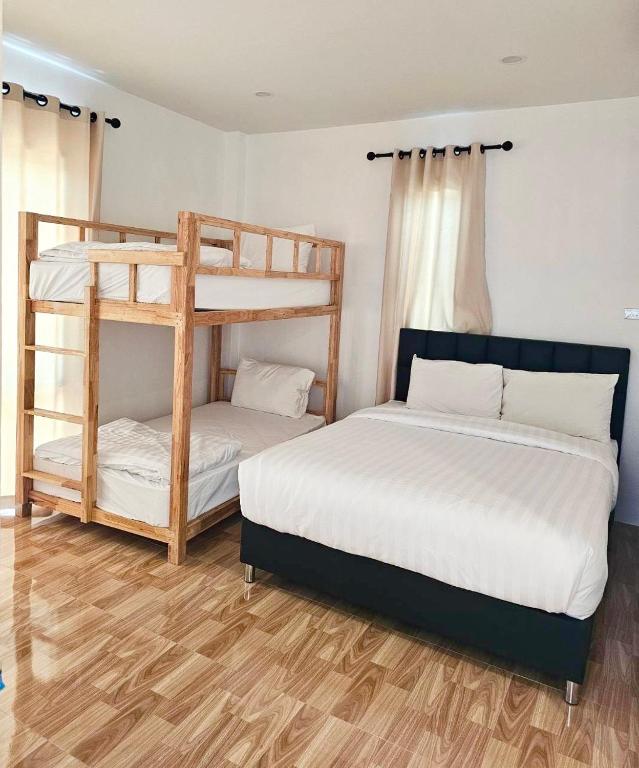 Postel nebo postele na pokoji v ubytování Vamin Poolvilla Chiangkhan Loei วามินทร์พูลวิลล่า เชียงคาน เลย - วามินทร์ รีสอร์ท