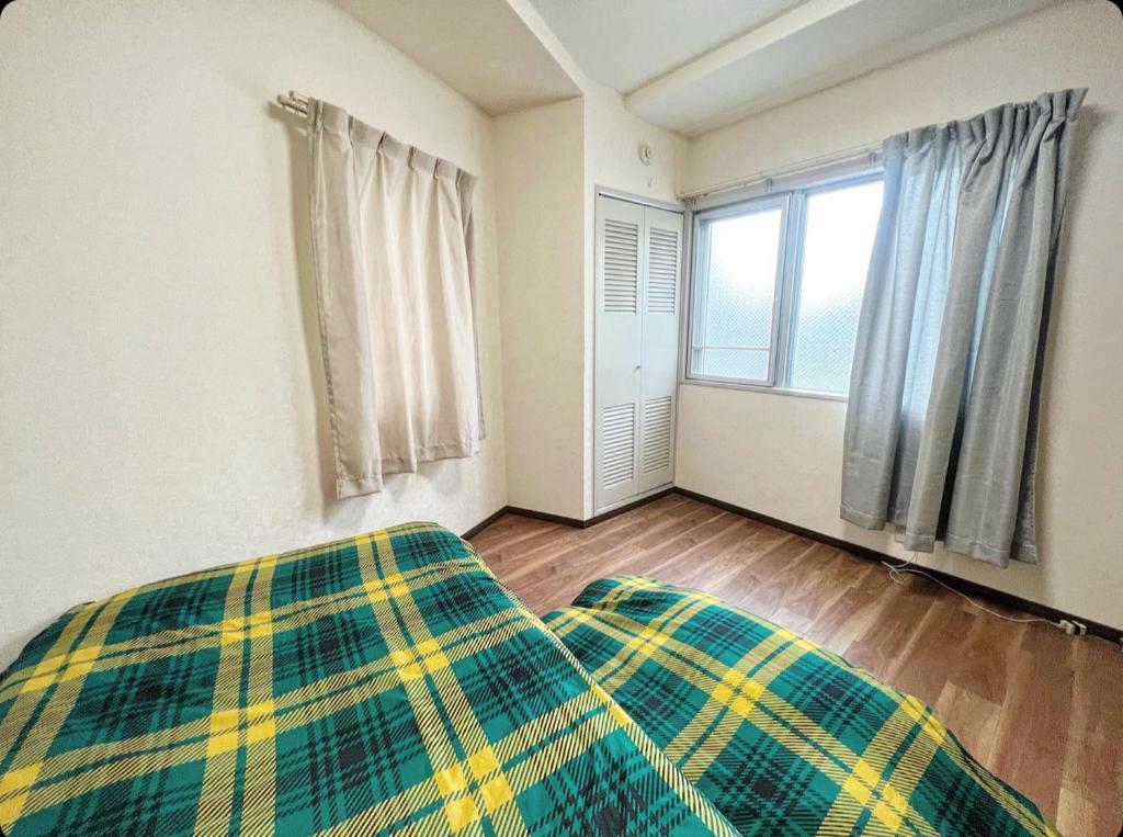 Postel nebo postele na pokoji v ubytování MATUBARA HOUSE