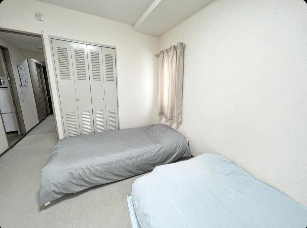 Postel nebo postele na pokoji v ubytování MATUBARA HOUSE