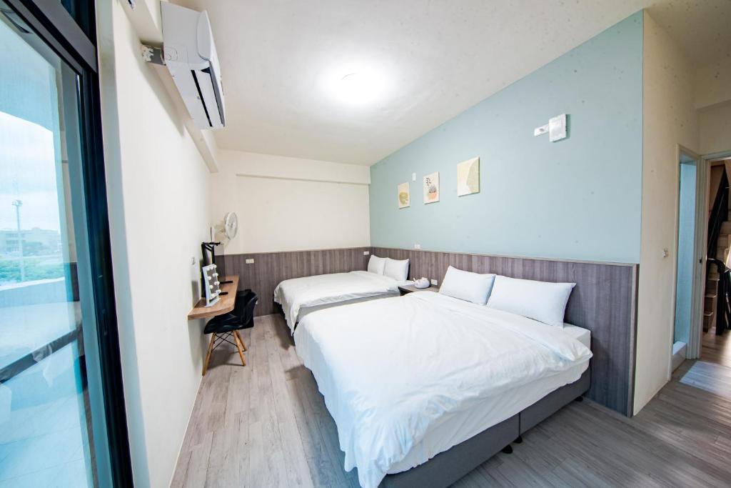 Postel nebo postele na pokoji v ubytování 烽閤民宿 Fengge