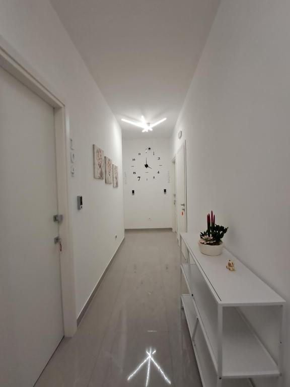 an empty hallway with white walls and a white door at Rovelli House in Foggia