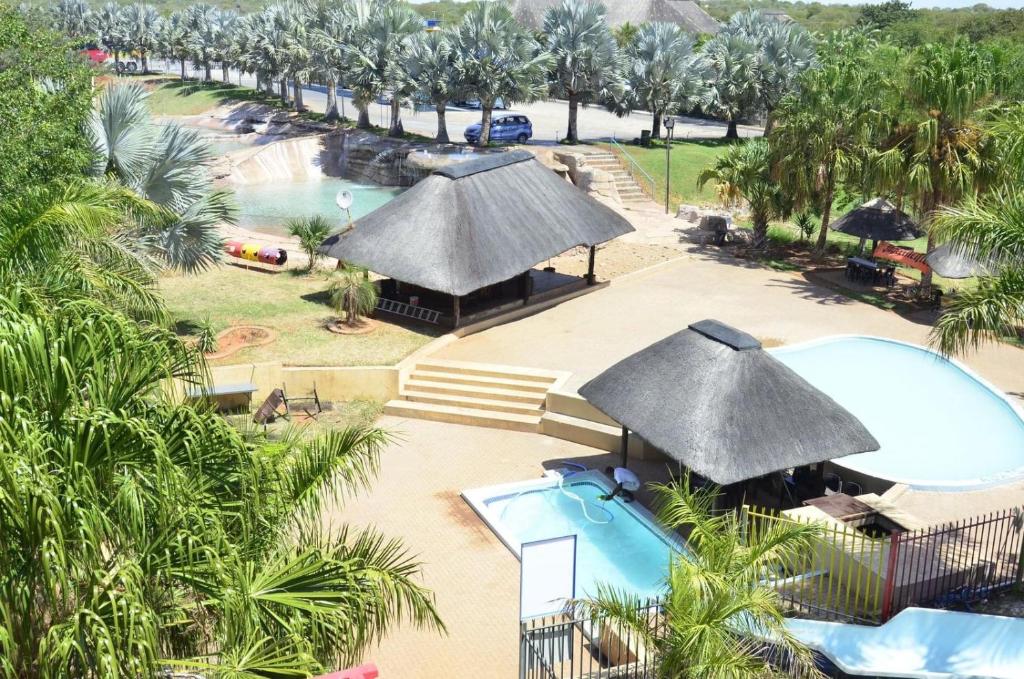 an aerial view of a resort with a pool and umbrellas at Sandriver Resort in Musina