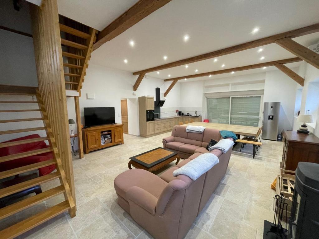 a living room with two couches and a tv at Gite des 5V in Gerbépal