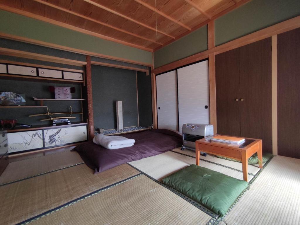 a room with a bed and a table in it at One person Random room Local house stay- Vacation STAY 40532v in Hida