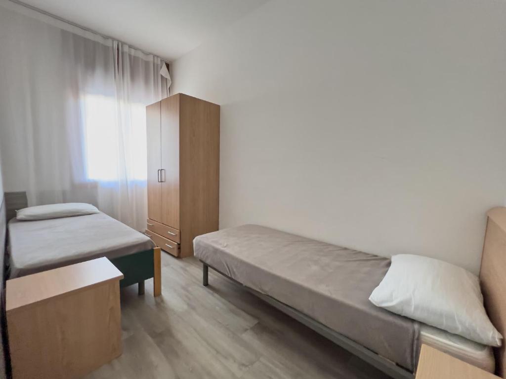 Posteľ alebo postele v izbe v ubytovaní Appartamenti Diplomatic-Residence Fronte mare-Piazza Torino-Lido di Jesolo