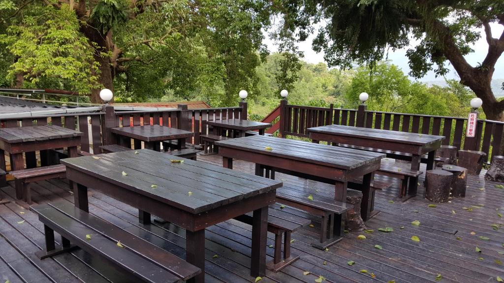 a group of picnic tables and benches on a deck at JS Hotspring in Ruisui