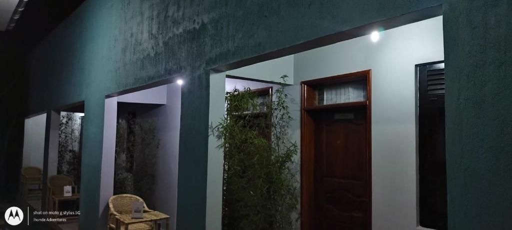 a room with a door and a green wall at KWERI GUEST HOUSE in Mbarara