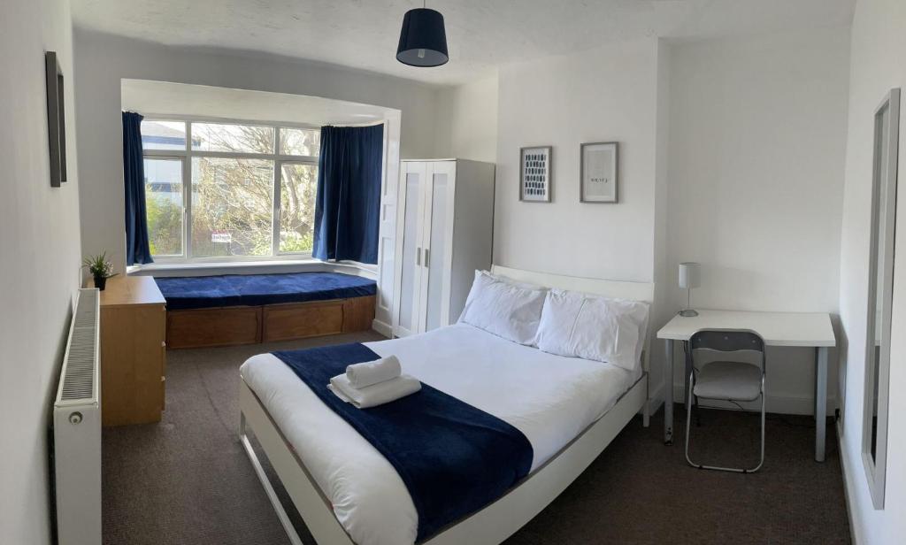a bedroom with a large bed and a window at The Anglesea - 8 Bedroom with Parking in Southampton