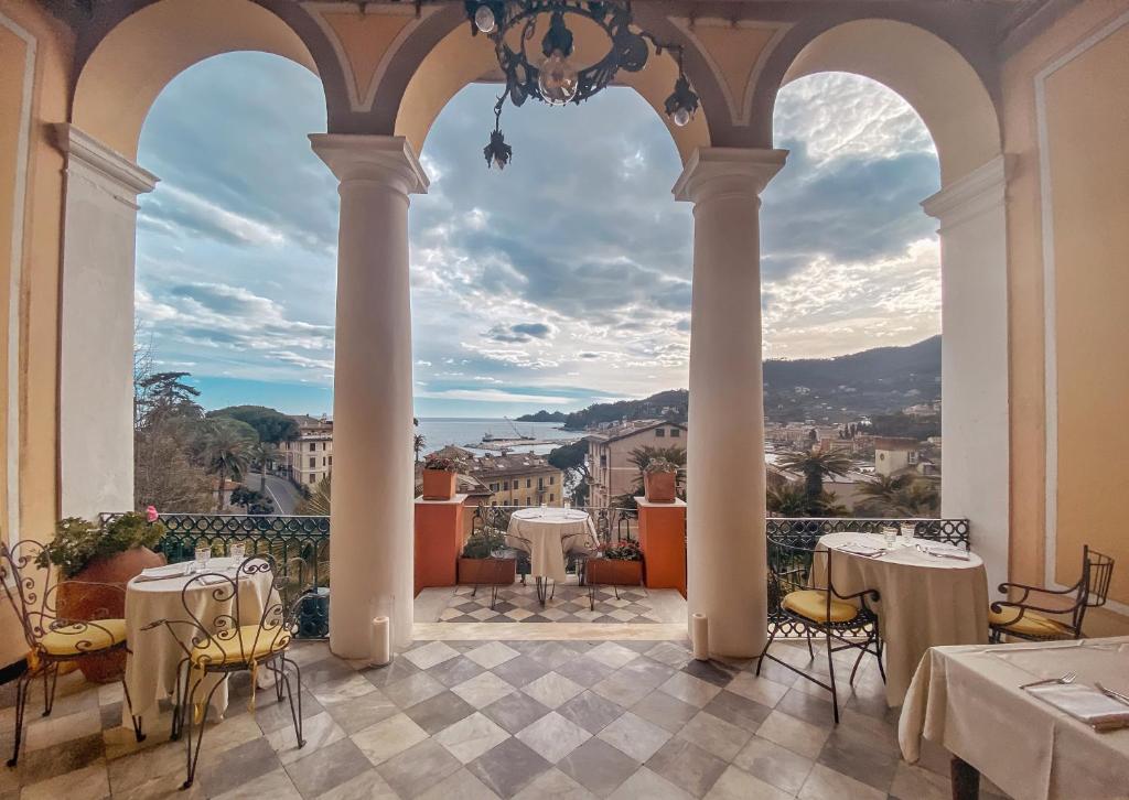 a view from the balcony of a restaurant with tables and chairs at Villa Gelsomino Exclusive House in Santa Margherita Ligure