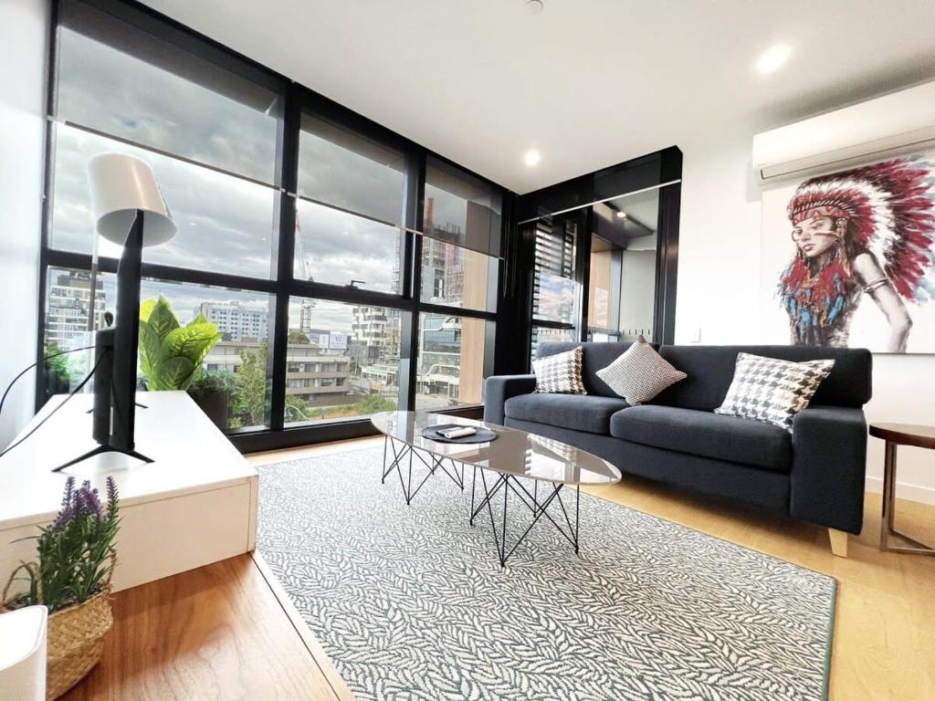 a living room with a couch and a table at Myka Home New Apartment in Box Hill YS4A in Box Hill
