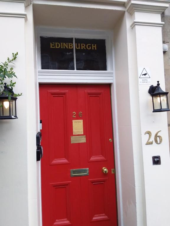 a red door in a white building with a window at IVY House in Edinburgh