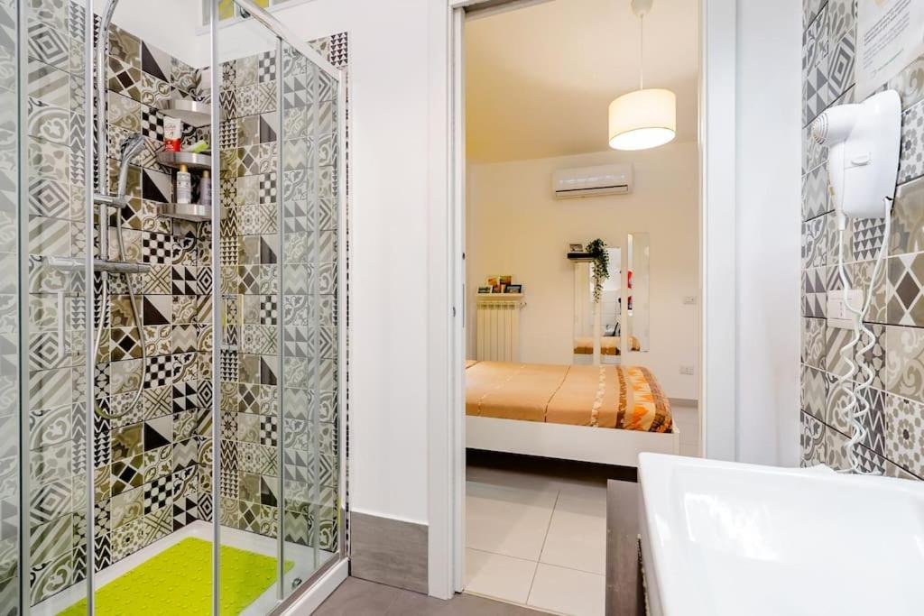 ein Bad mit ebenerdiger Dusche neben einem Schlafzimmer in der Unterkunft B & B Il Giardino sul Mare in Briatico