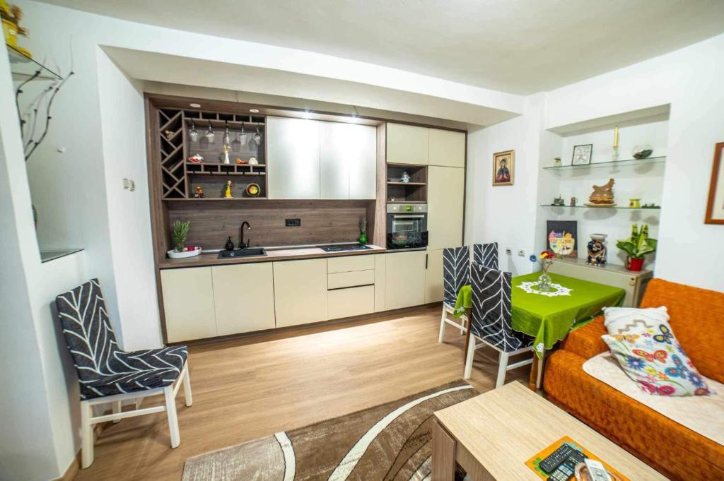 a kitchen and living room with a couch and a table at Apartman GIF in Trebinje
