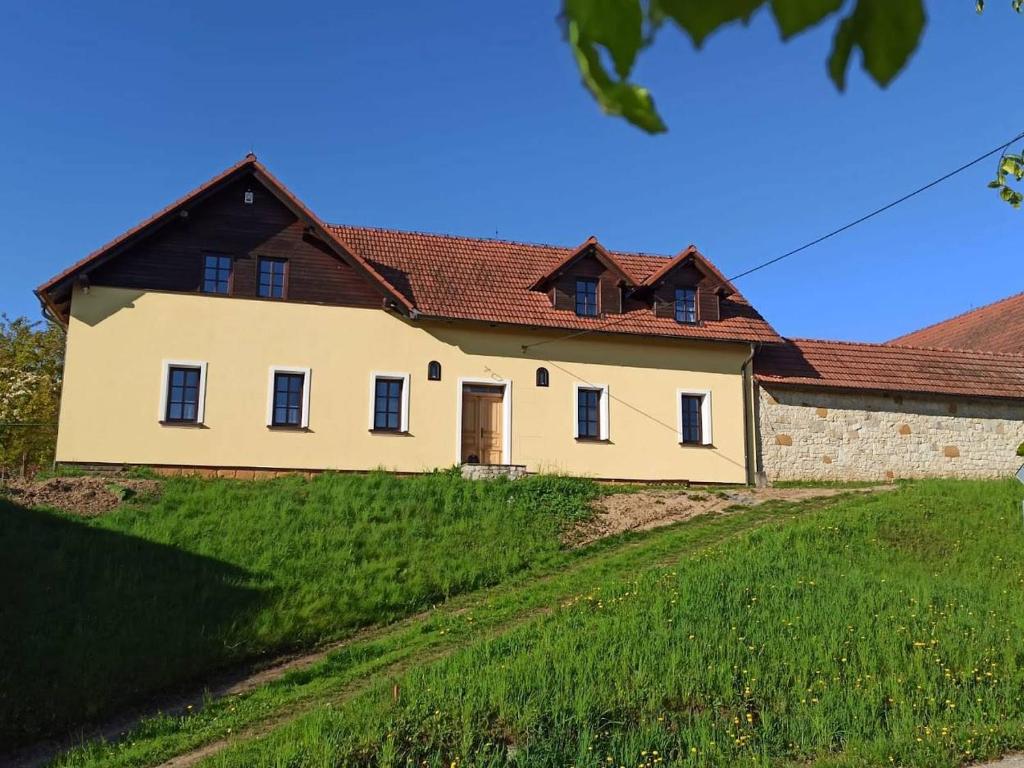 a large white house with a brown roof at Penzion Za plotem 