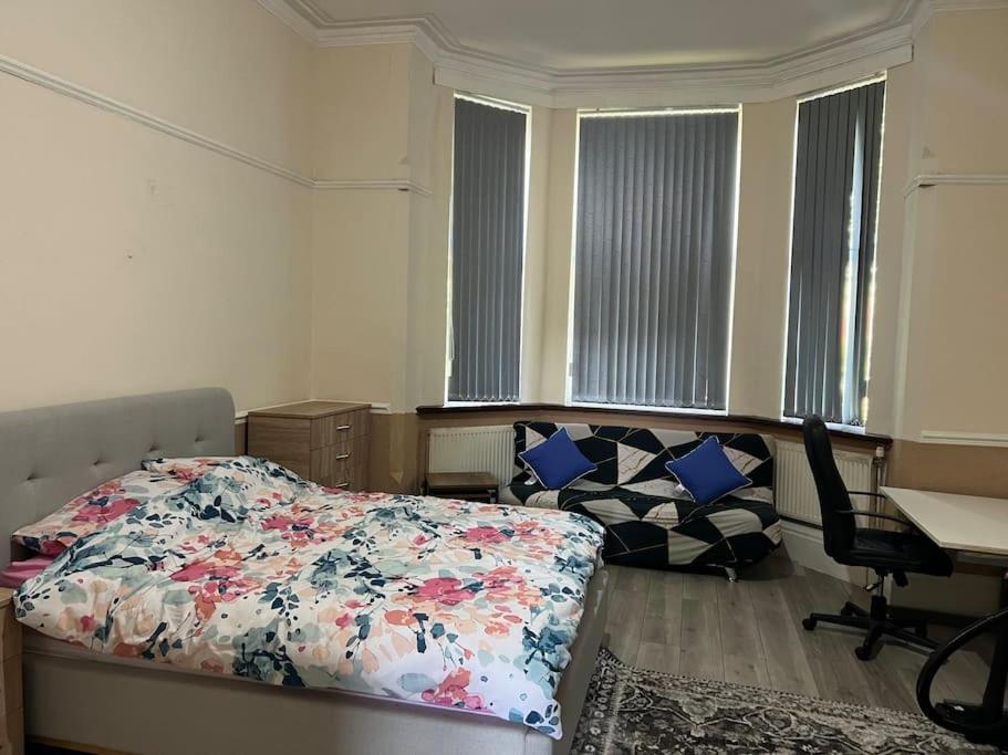 a bedroom with a bed and a desk and a desk at Spacious one bedroom flat w/ parking in Walsall