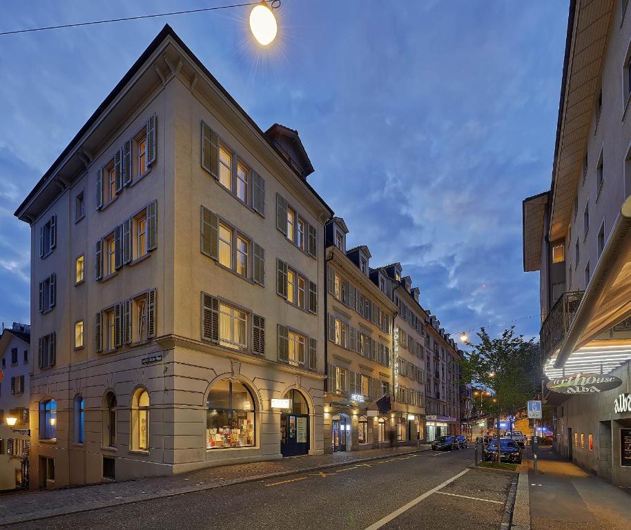 a large building on a city street at night at Sorell Hotel Rütli in Zürich