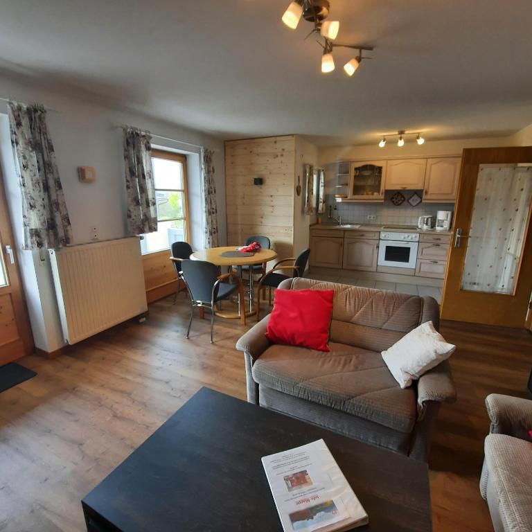 a living room with a couch and a table at Ferienwohnung Grüner in ruhiger, zentraler Lage von Burgberg im Oberallgäu in Burgberg