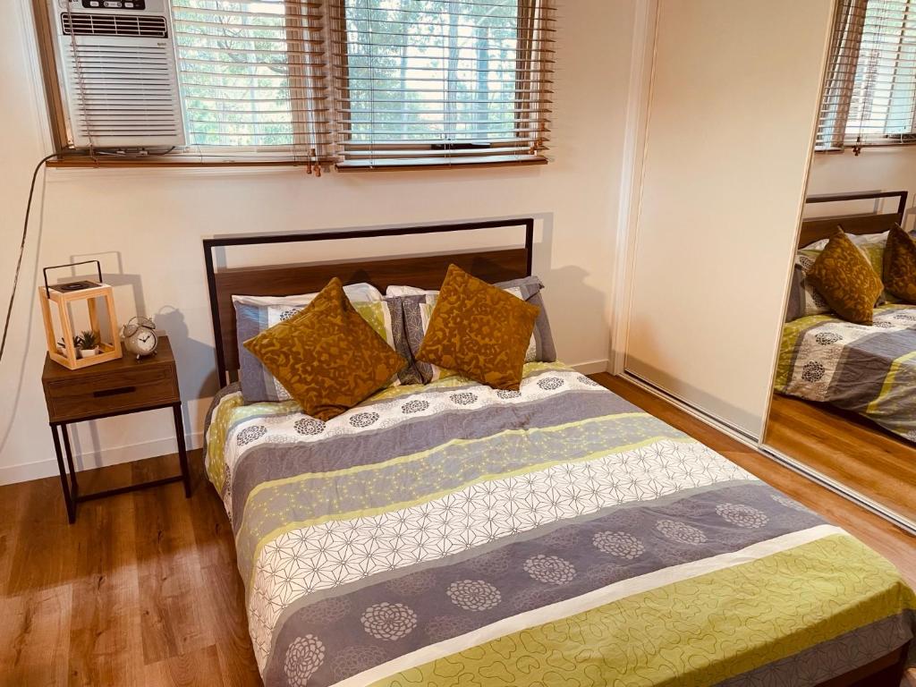 a bedroom with two beds and a mirror at Cozy Room Next to Bond University in Gold Coast