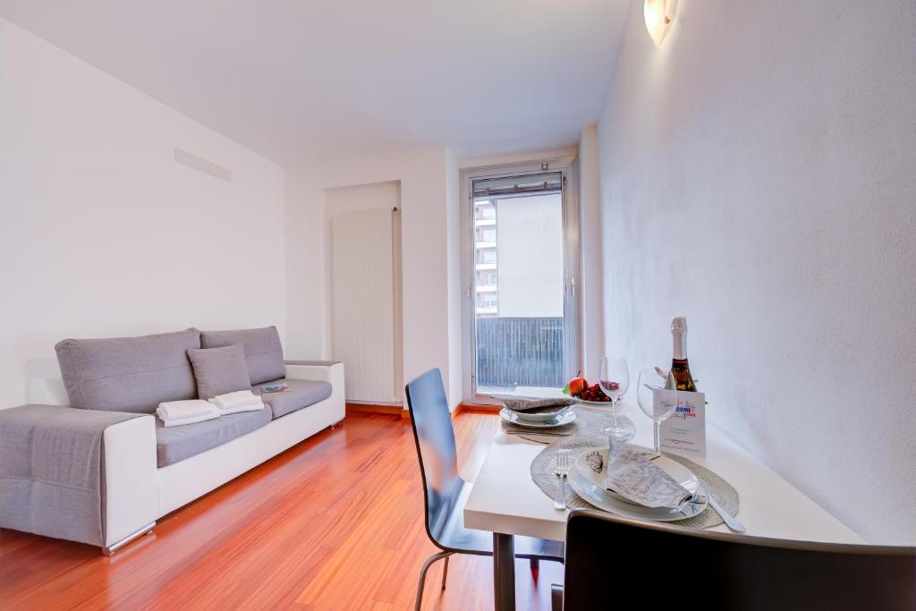 a living room with a table and a couch at Moonlight - Happy Rentals in Lugano