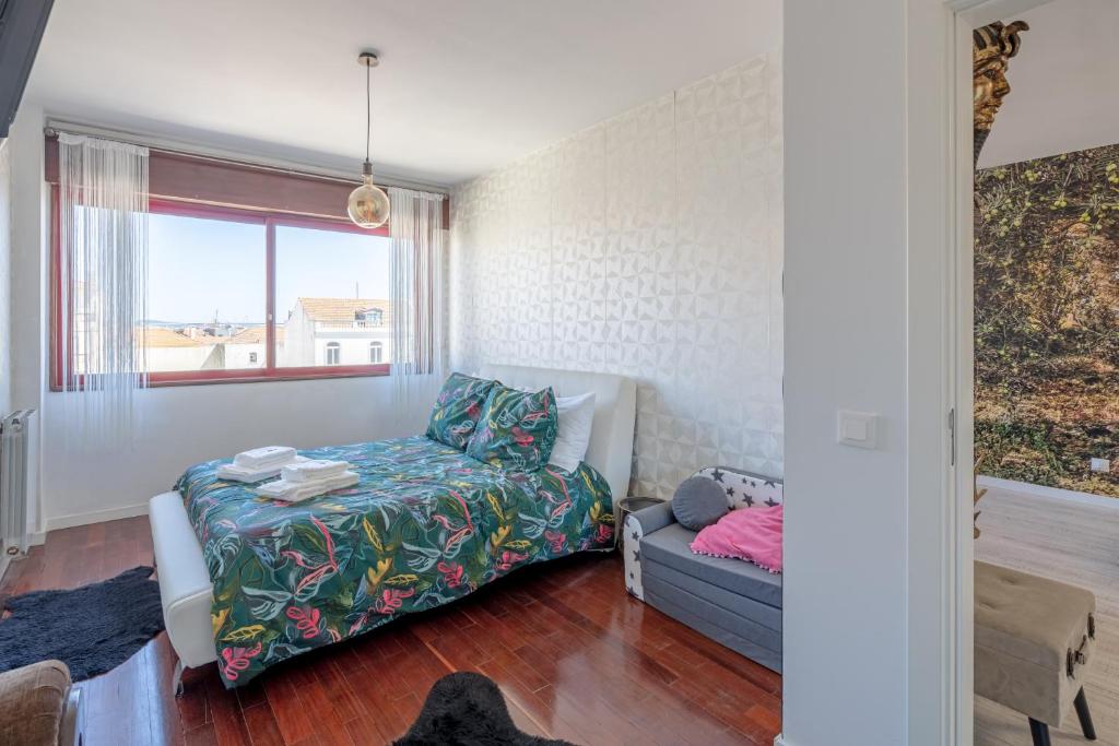 a living room with a couch and a chair at RA FIGUEIRA DA FOZ in Figueira da Foz