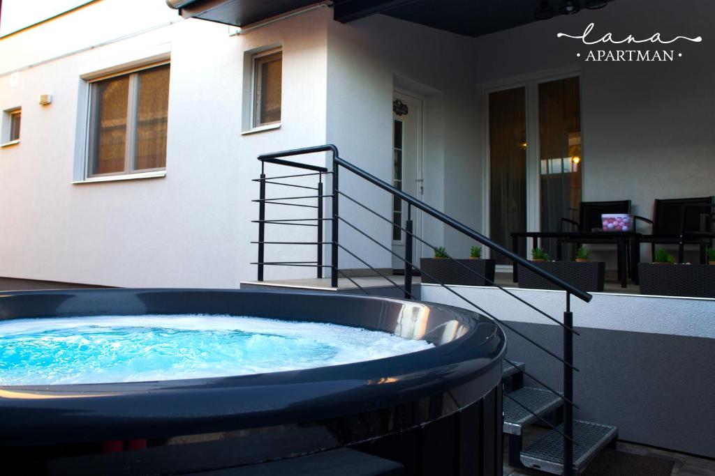 a hot tub in the backyard of a house at Lana apartman in Makó