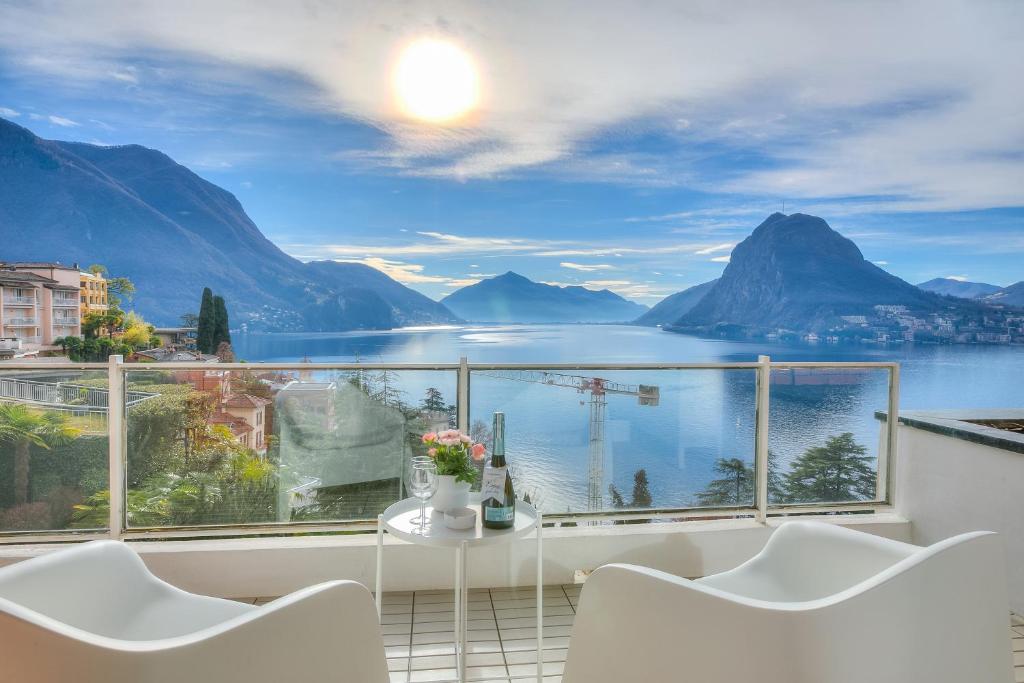 a balcony with a view of the water and mountains at Honeymoon with Stunning View - Happy.Rentals in Castagnola