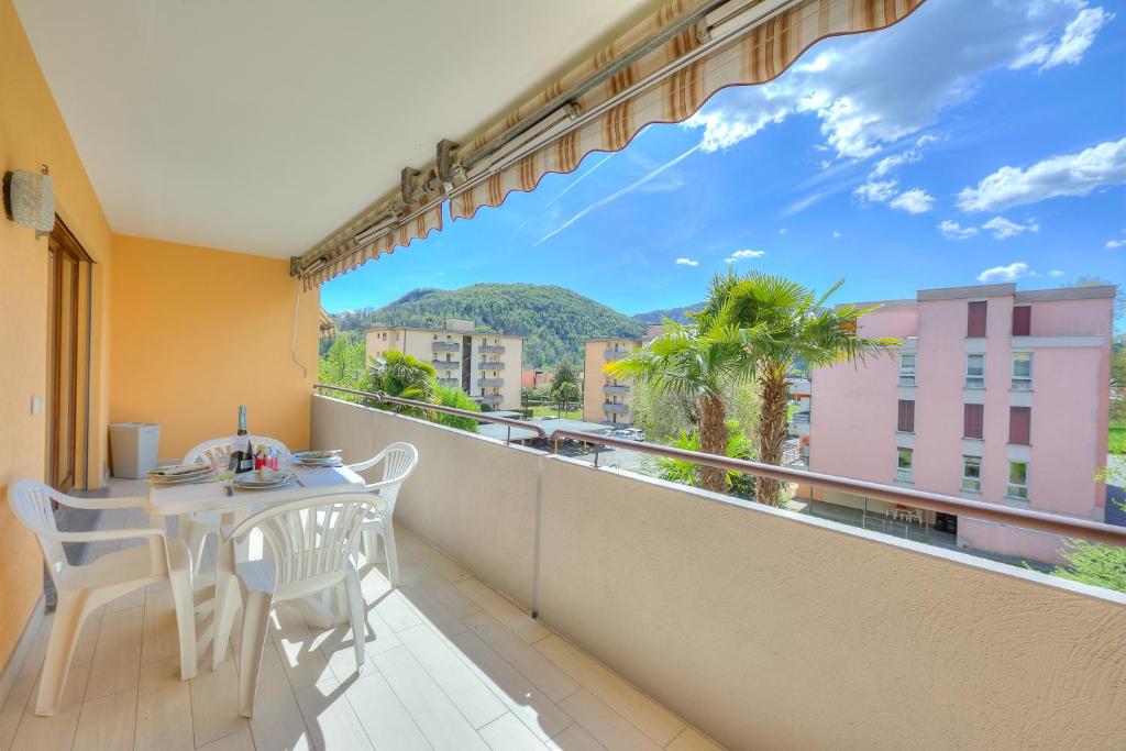 a balcony with a table and chairs and a view at Casa Bruna Few Min From Lake - Happy Rentals in Caslano