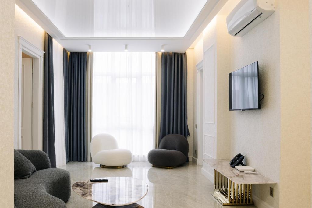 a living room with a couch and a table at Luxurious Mamu Apartment in Batumi