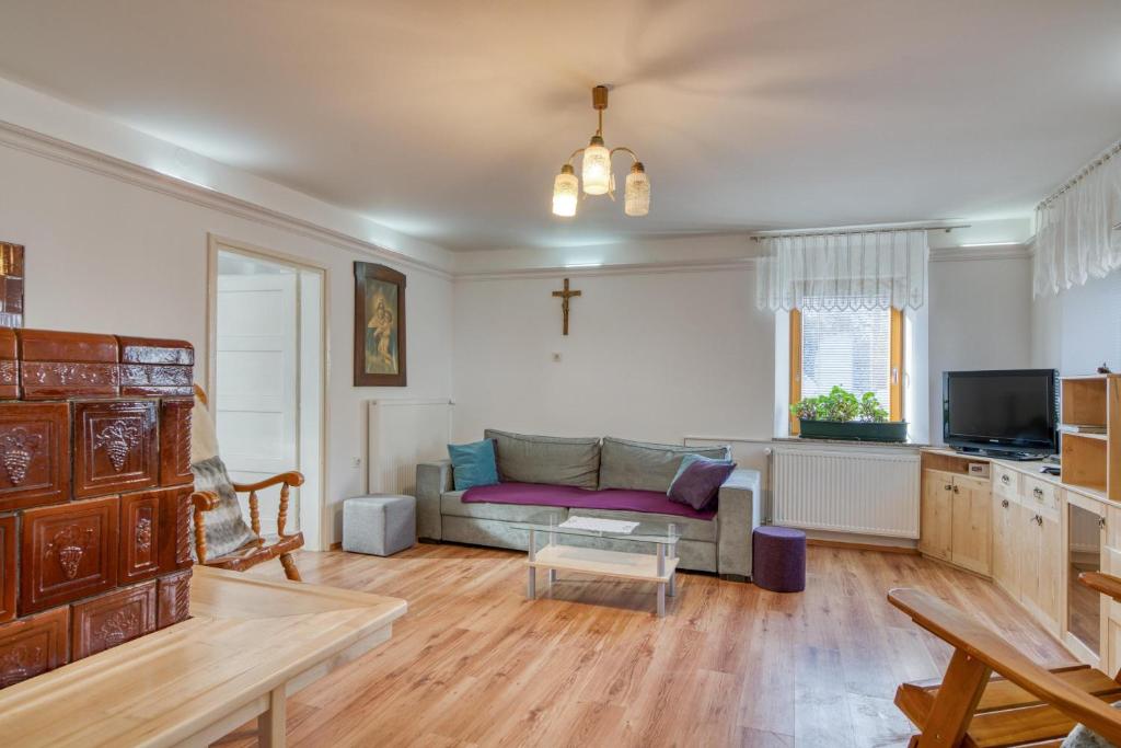 a living room with a couch and a table at Farmhouse Blackberry Pool & Wellness- Happy Rentals in Vransko