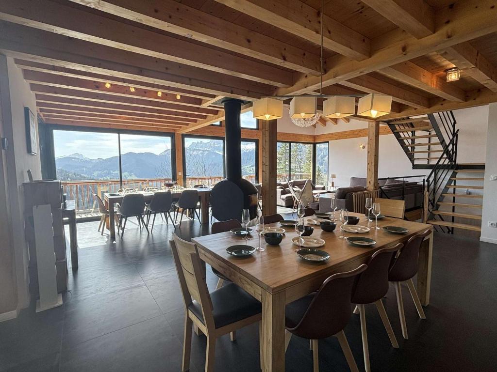 a dining room with a large wooden table and chairs at Chalet Notre-Dame-de-Bellecombe, 8 pièces, 15 personnes - FR-1-595-1 in Notre-Dame-de-Bellecombe