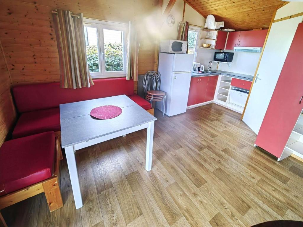 a small living room with a table and a kitchen at Chalet Agde, 3 pièces, 6 personnes - FR-1-607-59 in Agde