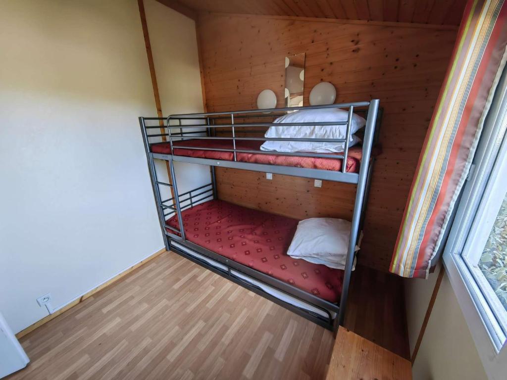 two bunk beds in a small room with a window at Chalet Agde, 3 pièces, 6 personnes - FR-1-607-59 in Agde