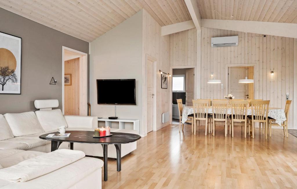 a living room with a white couch and a table at Nice Home In Sjølund With Wifi in Sjølund